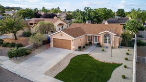 A residential house with a garage, a lawn, and a driveway. - Desert Pool Oasis located in the heart of Las Cruces (Las Cruces)