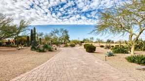 A paved pathway in a desert garden with various cacti and trees. - Private Phoenician Sanctuary- Villa De Paz (Phoenix)