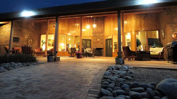 A modern building with a covered patio area, large windows, and outdoor seating. - Rancho Venado Tucson, One of a kind, spiritual desert oasis in NE Tucson (Tucson)