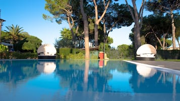 Seasonal outdoor pool, an infinity pool, pool umbrellas, pool loungers