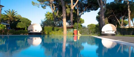 Seasonal outdoor pool, an infinity pool, pool umbrellas, pool loungers