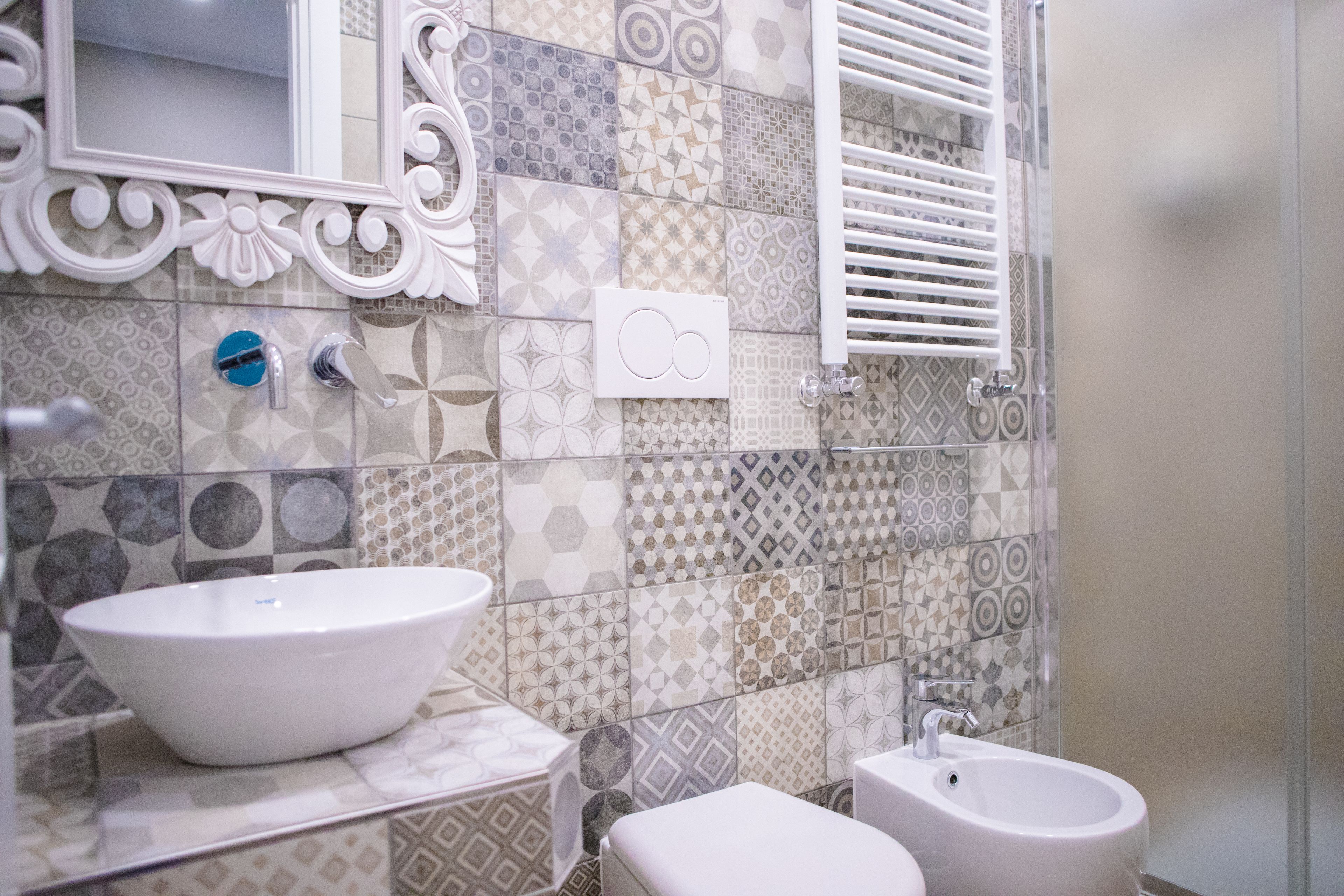 A bathroom with a white sink, a bidet, and a mirror.