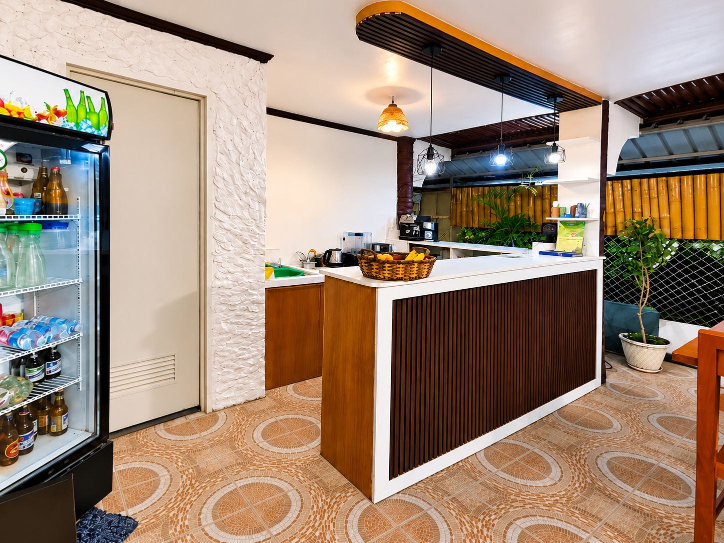 A modern kitchen with a built-in refrigerator, a wooden counter, and a patterned floor.