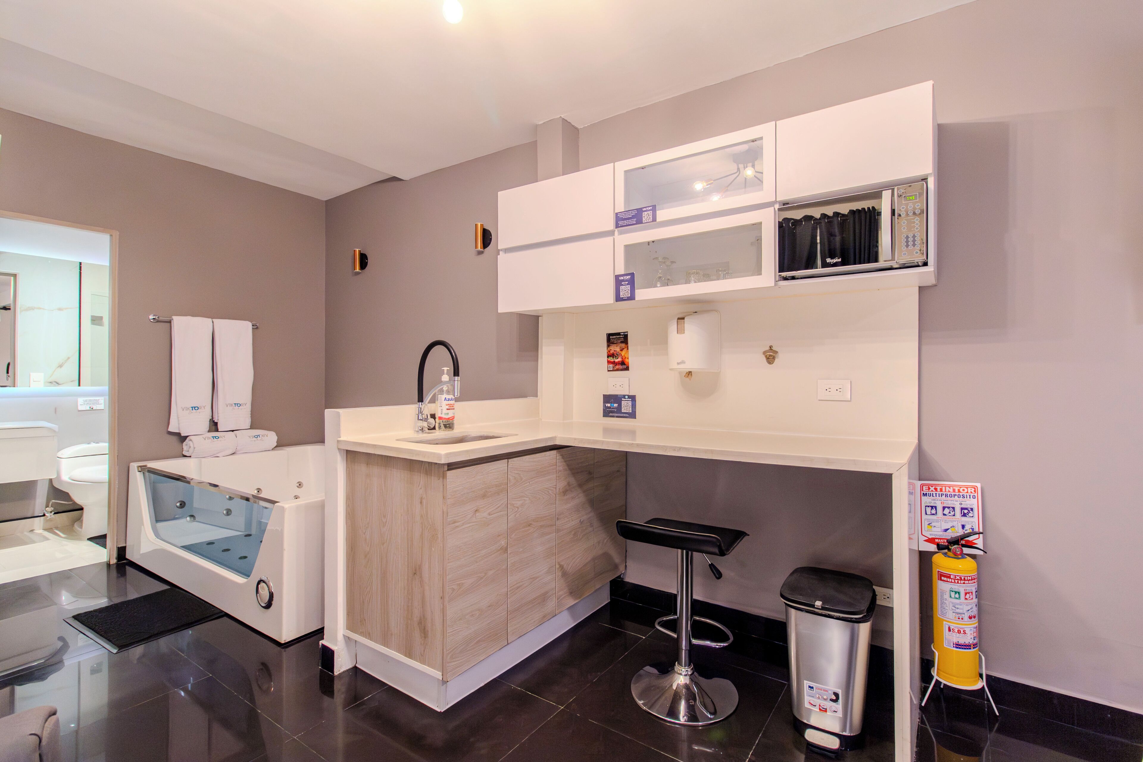 A modern bathroom with a bathtub, a sink, a toilet, and a shower area.