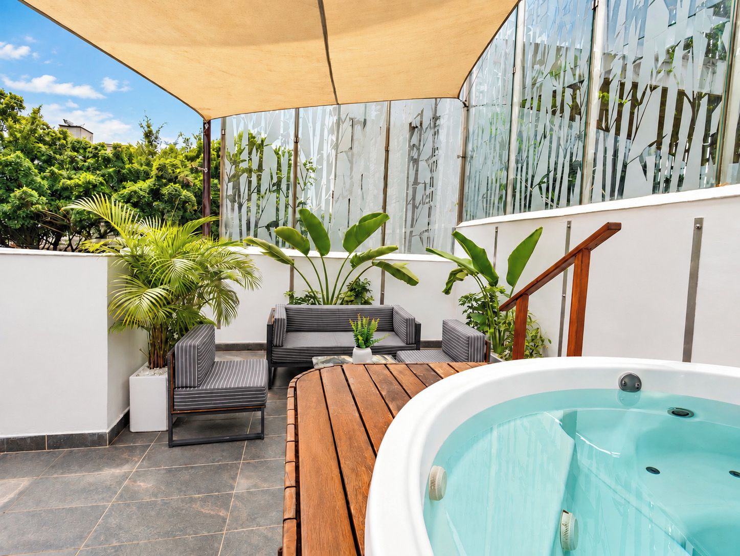A rooftop terrace with a hot tub, outdoor seating, and potted plants.