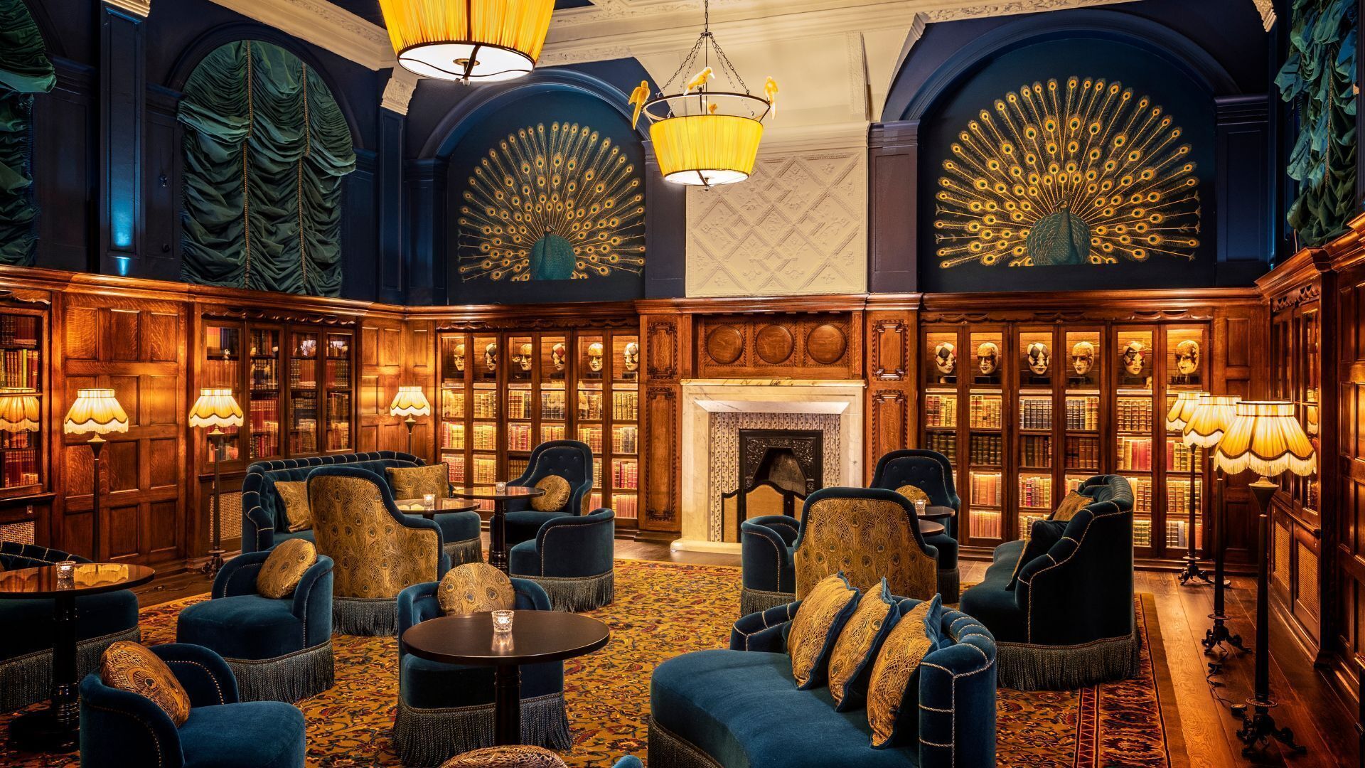 A luxurious lounge area with plush seating, ornate wood paneling, and a grand fireplace.