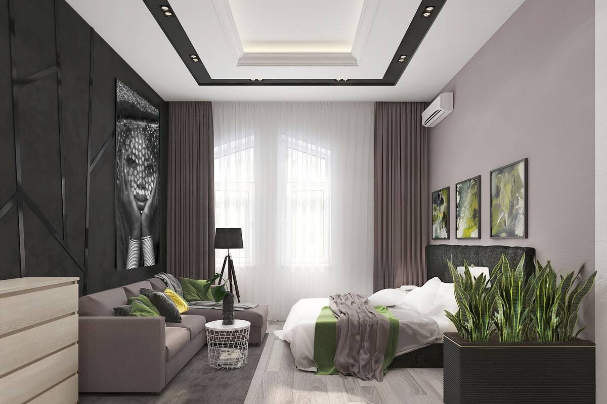 A modern bedroom with a bed, a sofa, a small table, and a large potted plant.
