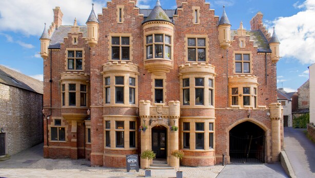 A large, historic building with multiple windows and a prominent entrance. - The Fleece Hotel (Richmond)