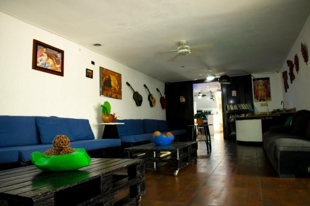 A living room with blue sofas, a coffee table, and a ceiling fan.