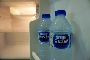A refrigerator with two Nestlé Pure Life water bottles inside.