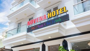 The Novena Hotel with a prominent sign displaying the address 302 Phan Chu Trinh. - Khach San Novena (Ho Chi Minh City)