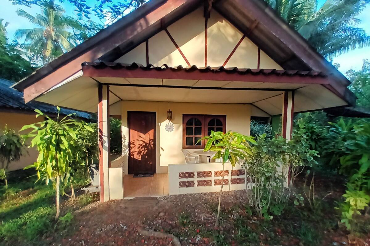 A house with a porch, a door, and a window.