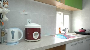 A kitchen with a built-in oven, a kettle, and a sink. - LotteTower Rainbow House (Seoul)