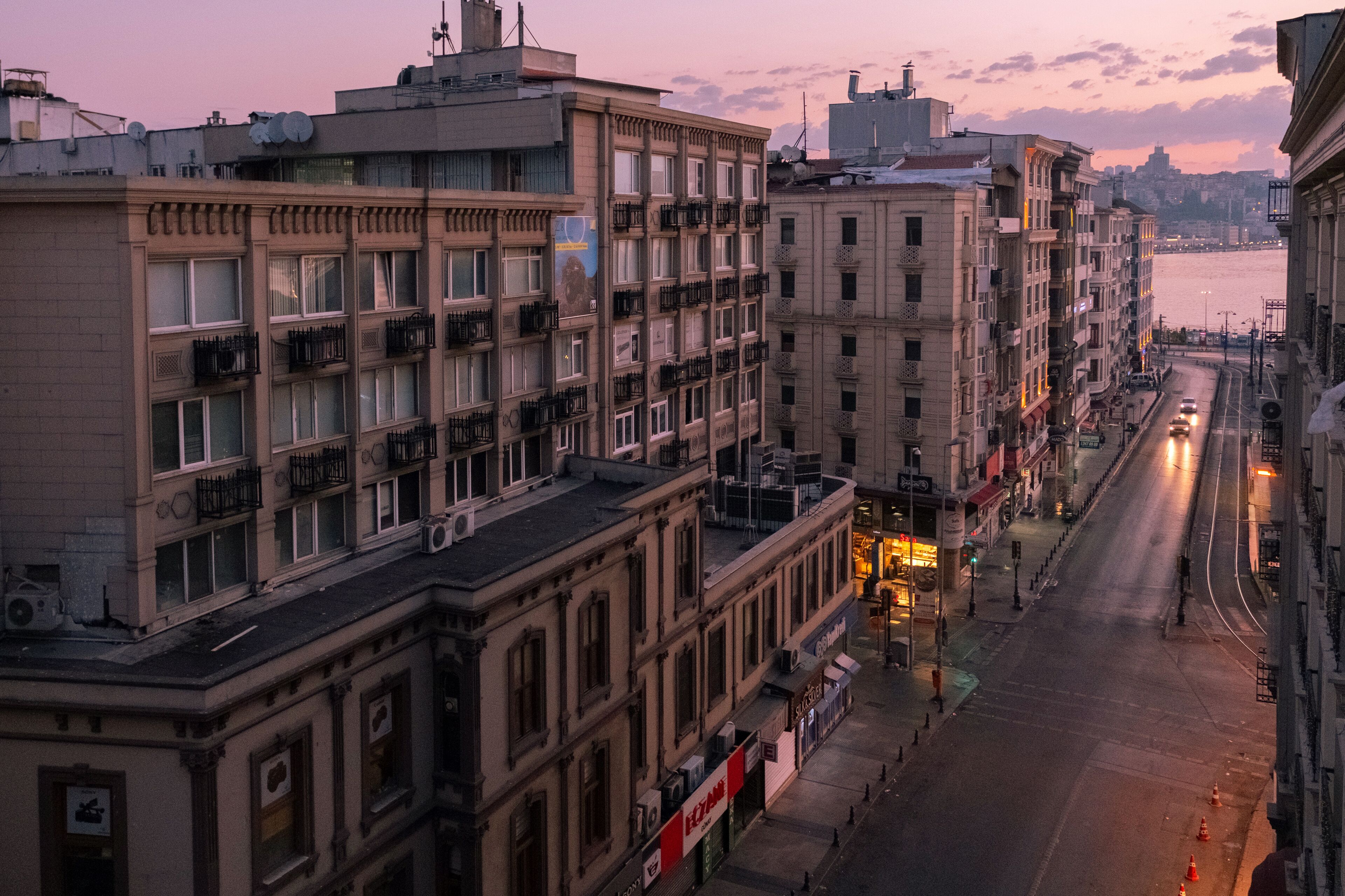 A multi-story building with balconies and a street view.
