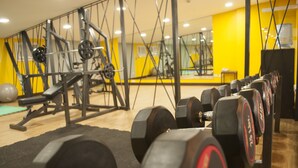 A gym with weightlifting equipment, mirrors, and a yellow wall. - Studio 89 Katipunan QC (Quezon City)