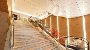 A modern indoor staircase with glass railings and a handrail, leading to an upper floor. - Richmond Hotel Utsunomiya Ekimae Annex (Utsunomiya)
