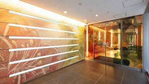 A modern interior with a glass wall, a colorful abstract mural, and a tiled floor. - Richmond Hotel Utsunomiya Ekimae Annex (Utsunomiya)