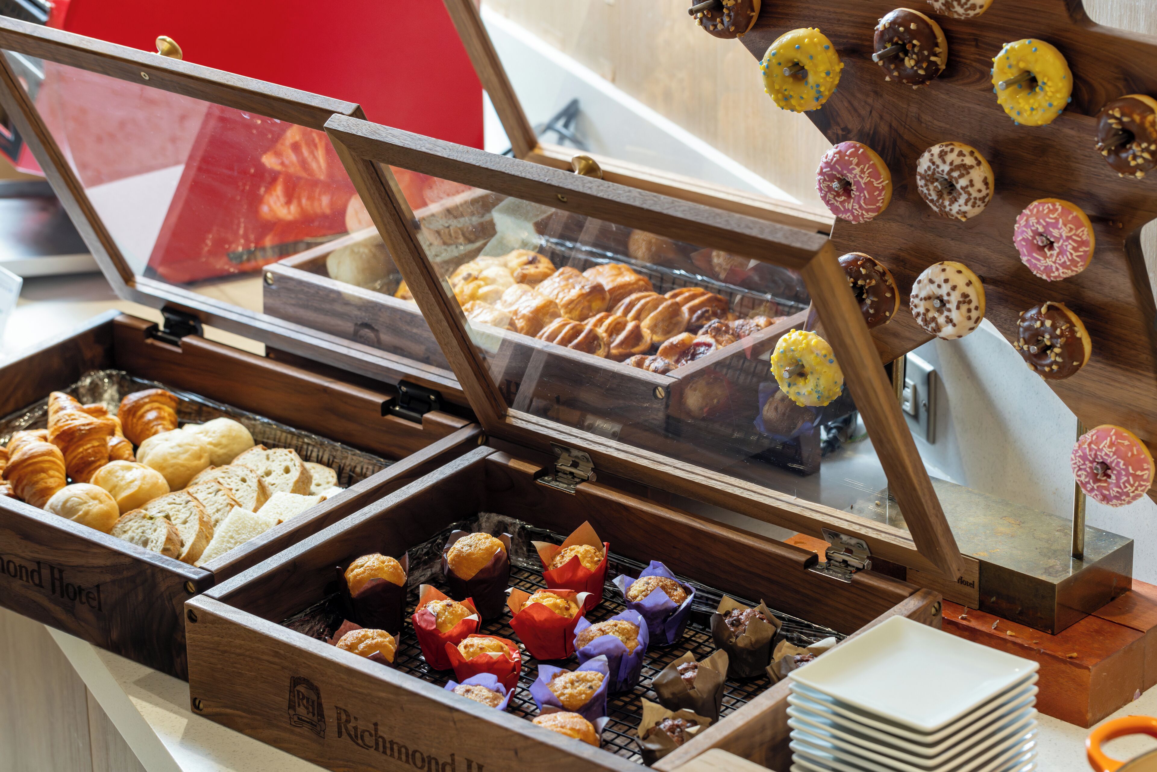 A bakery display case with various baked goods including pastries and donuts.