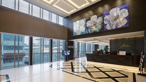 A spacious lobby with large windows, a reception desk, and artwork on the walls. - Asti Hotel Busan Station (Busan)