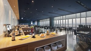 A modern breakfast area with a buffet setup, including various food items and a coffee station. - Asti Hotel Busan Station (Busan)