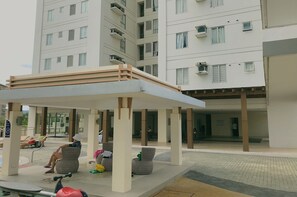 A covered outdoor seating area with lounge chairs and a poolside setting. - 1BR Condominium at Avida Towers Cebu IT Park (Cebu City)