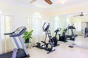 A home gym with a treadmill, elliptical, and stationary bike. - Mais oui Tennis and Spa Villa (Rio Bueno)