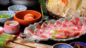 A variety of food items including sliced meat, vegetables, and bowls of condiments.