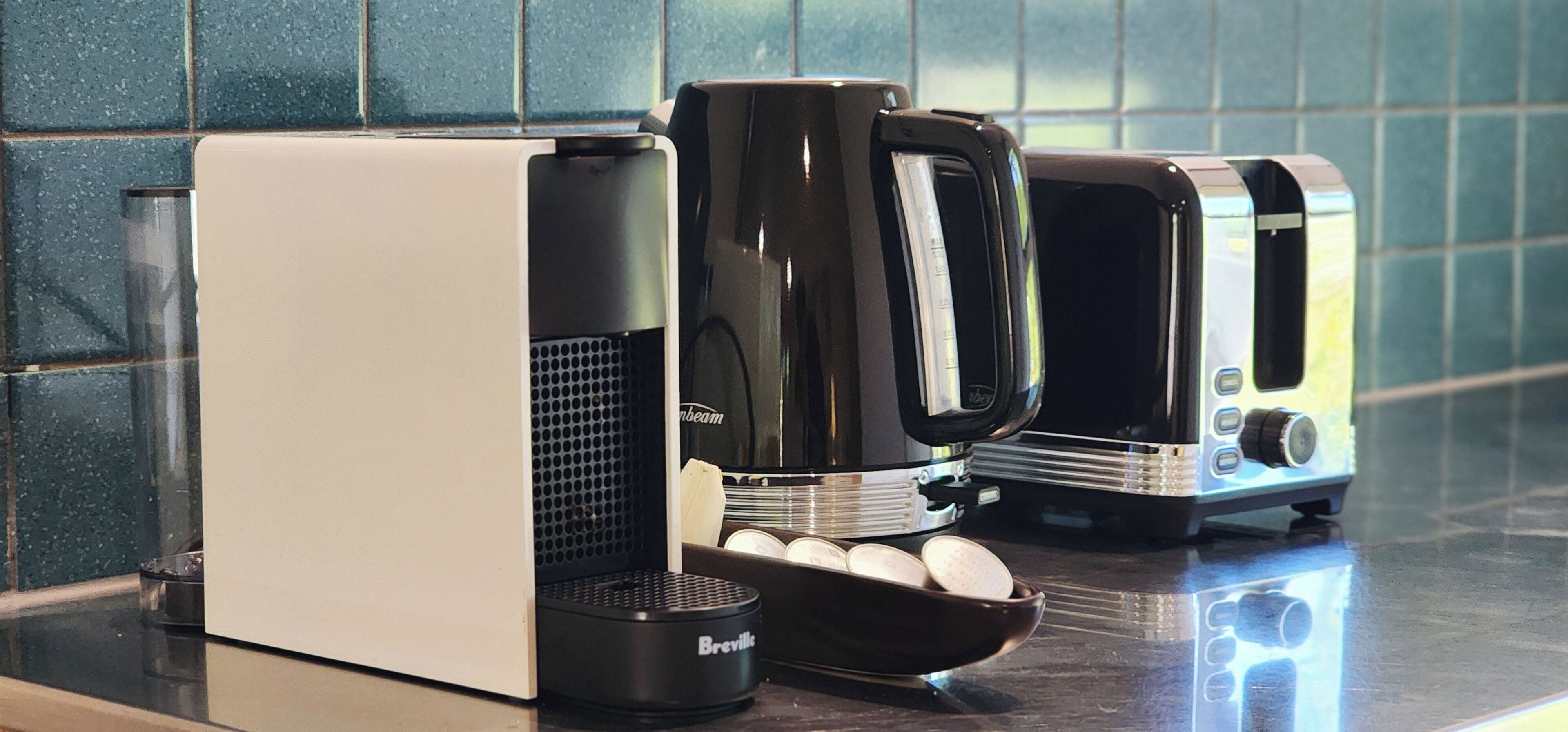 A Breville coffee maker on a kitchen counter with a Breville coffee pot and a Breville espresso machine.