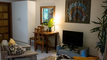 Deluxe Double Room | Living area | Flat-screen TV