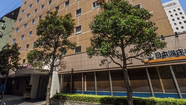 A tall hotel building with multiple floors, a visible entrance, and a sign indicating it is a hotel. - Richmond Hotel Utsunomiya Ekimae (Utsunomiya)
