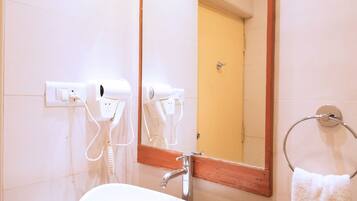 A bathroom with a white sink, a mirror, and a towel rack.