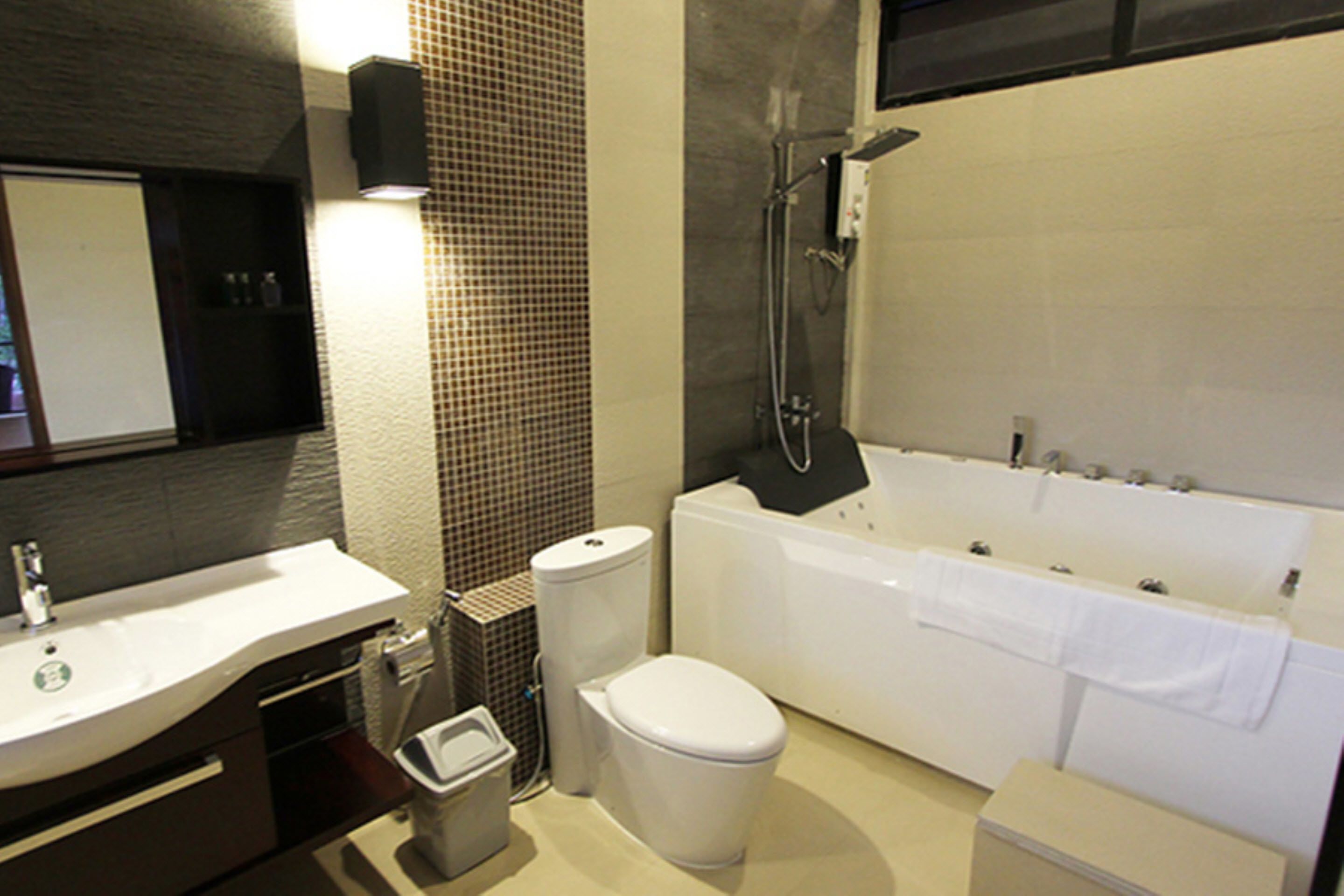 A modern bathroom with a white sink, toilet, and bathtub.