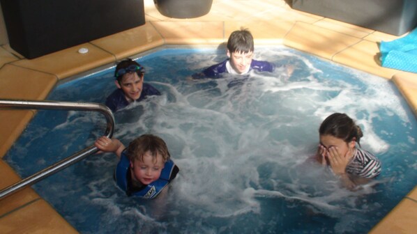 A hot tub with four people in it.