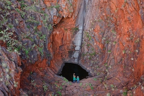 A large natural rock formation with a narrow opening at the bottom. - Cheela Plains Station (Nanutarra)