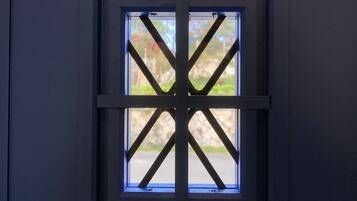 A window with a black metal grid design.