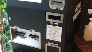 A money exchange machine with multiple service options including bill insertion, receipt outlet, and coin outlet. - HOTEL SUI AKASAKA byABEST (Tokyo)