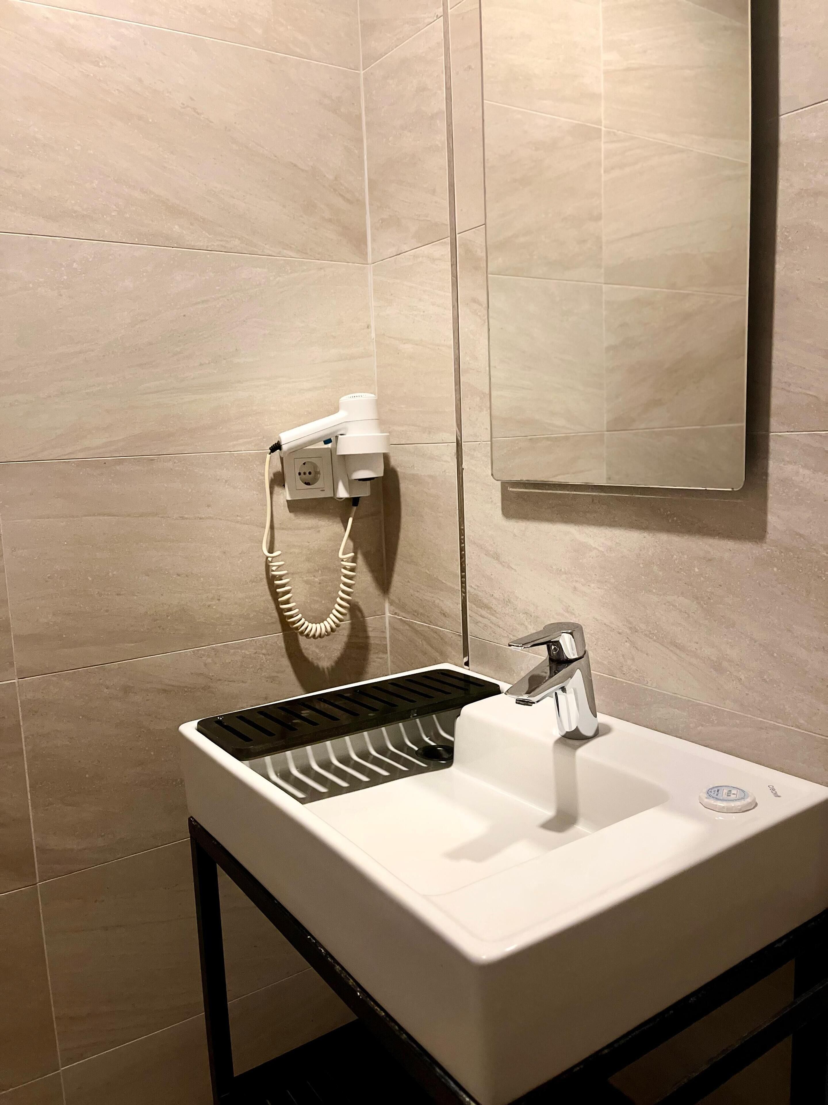 shower, hair dryer, bidet, towels