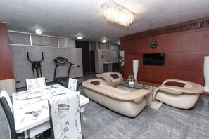 Luxury Apartment, Multiple Beds | Living room | Flat-screen TV, DVD player, streaming services - Deluxe Boutique Hotel (Baku)