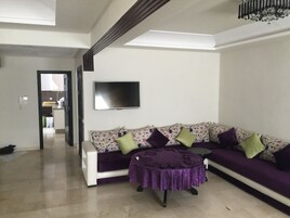 Deluxe Apartment, 3 Bedrooms, Accessible | Living room | Flat-screen TV