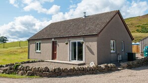A single-story house with a sloped roof, a front door, and a small porch. - Kennacoil (Dunkeld)
