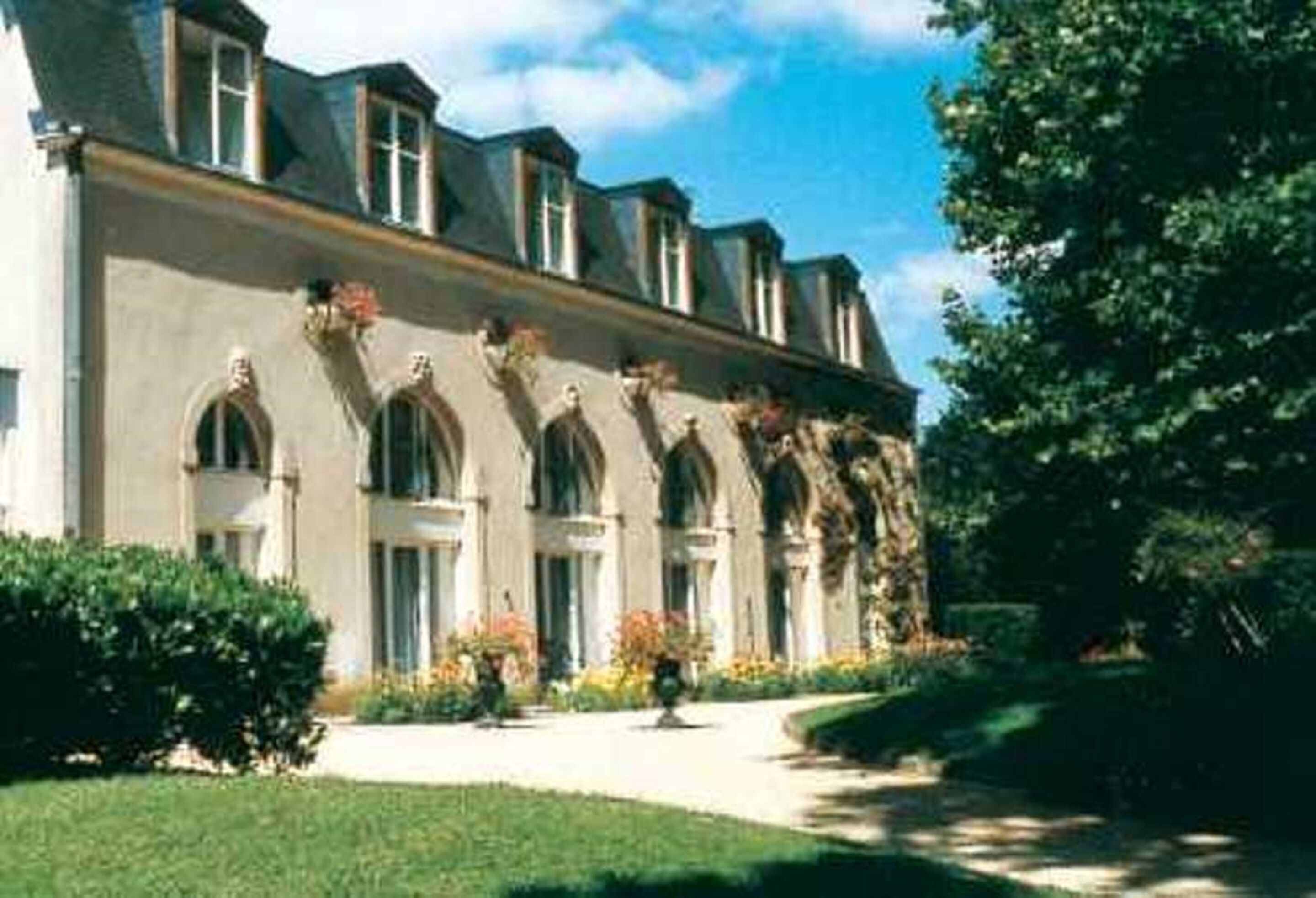 A large, historic building with arched windows and a symmetrical facade.