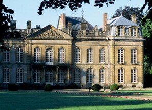 A large, historic building with symmetrical architecture, multiple windows, and a well-maintained lawn. - Chateau de Bazeilles (Bazeilles)