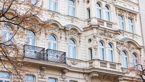 A historic building with ornate architectural details, multiple windows, and a decorative balcony. - Hapimag Resort Prague (Prague)