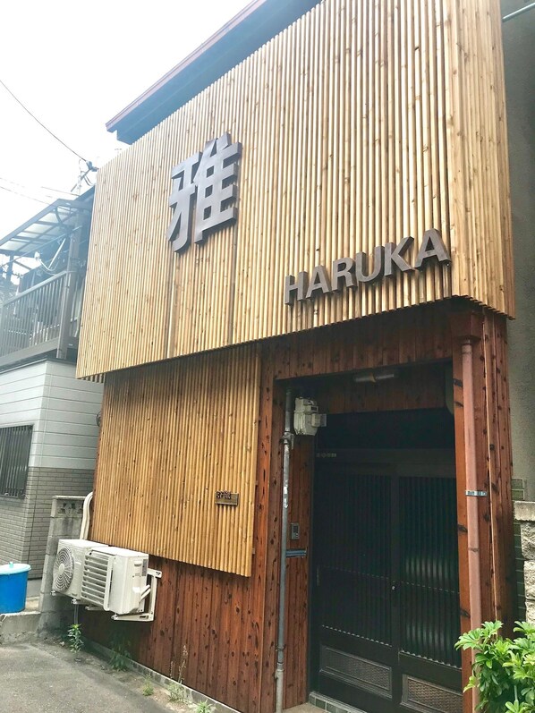 A building with a wooden facade and a sign that reads "HARUKA".