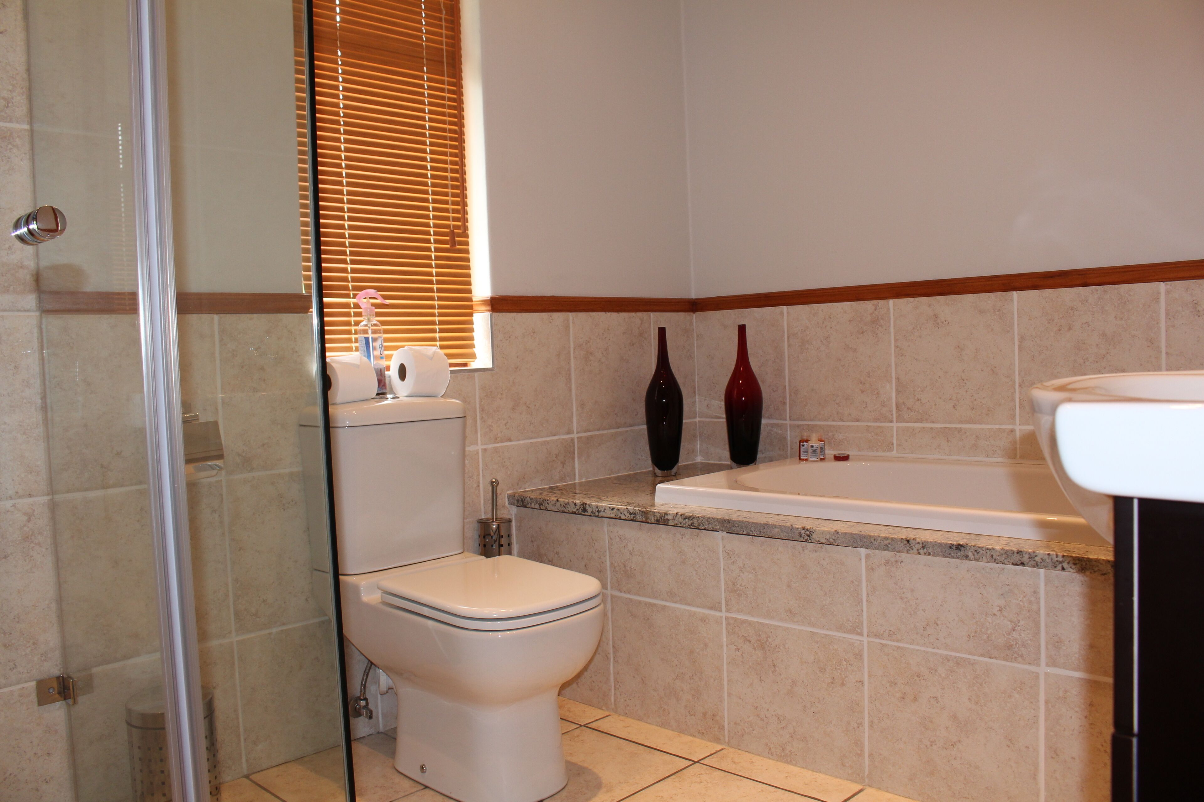 A bathroom with a toilet, a shower, and a bathtub.