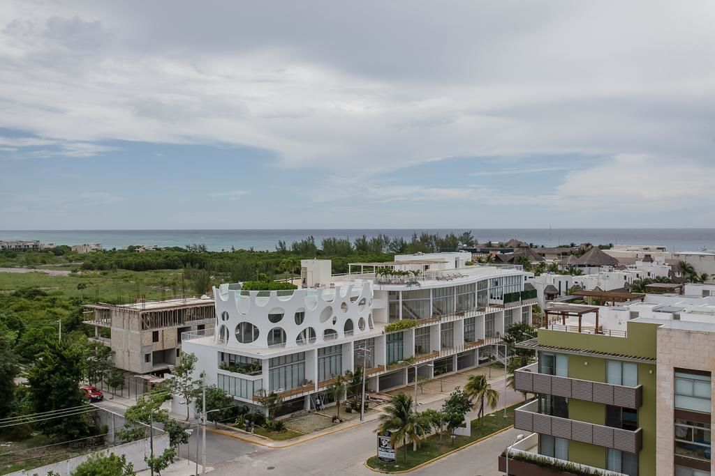 A modern hotel with a unique architectural design, featuring large windows and a central courtyard.