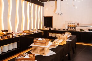 A buffet setup with various food items and beverages. - H Hotel (St. Julian's)