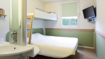 Ein kleines Zimmer mit einem Etagenbett, einem Nachttisch, einem Spiegel, einem Waschbecken und einem an der Wand befestigten Fernseher.