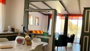 A dining area with a table set for two, a coffee machine, and a bag of snacks. - Résidence Filippi (Porto-Vecchio)