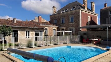 Seasonal outdoor pool, open 10:00 AM to 7:00 PM, pool umbrellas